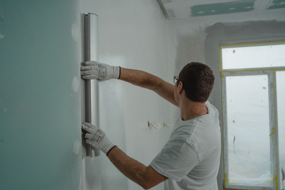 Contractor carefully measuring and planning a bathroom renovation