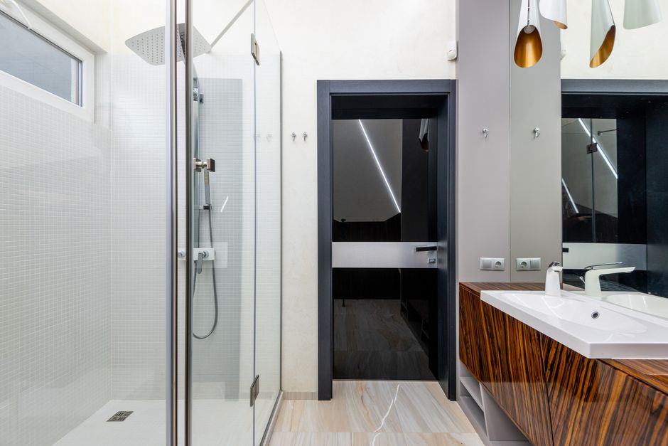 Modern walk-in shower installation with glass enclosure